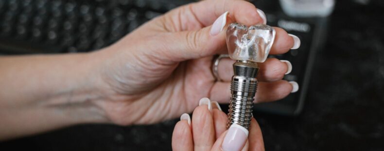 Dental implant model with crown showing a natural-looking option for replacing missing teeth in Reading, MA.