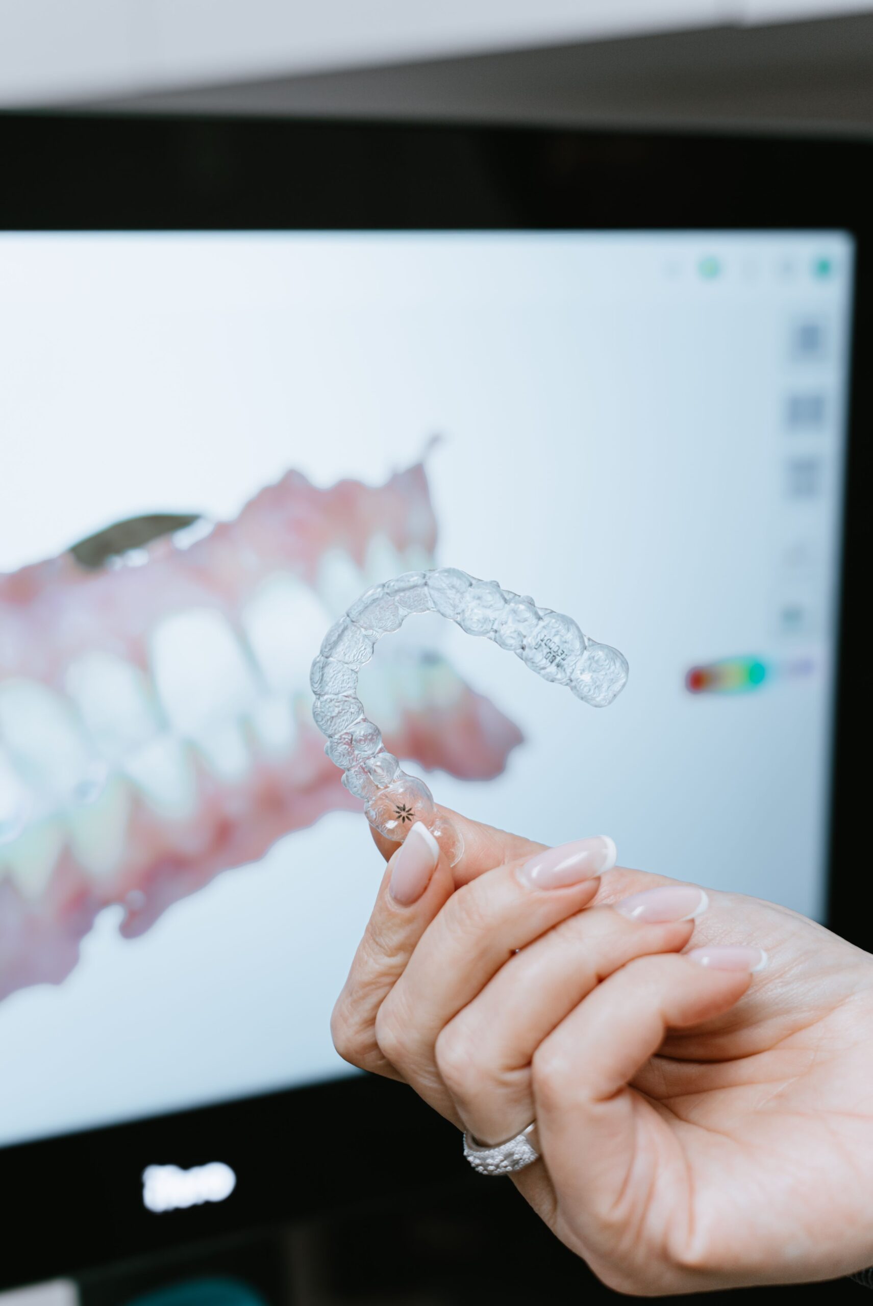 Invisalign clear aligner shown with a digital 3D teeth scan at Prima Family Dental in Reading, MA.