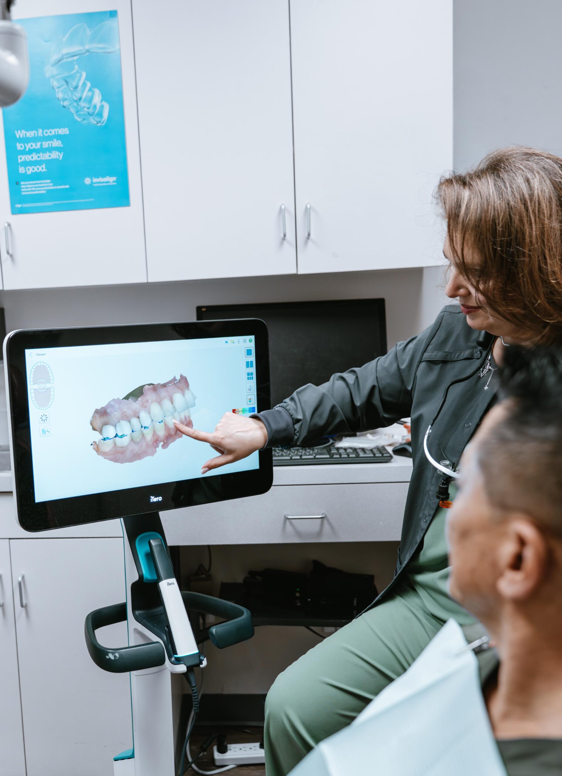 Prima Family Dental dentist reviews an iTero digital scan with an Invisalign patient in Reading, MA.